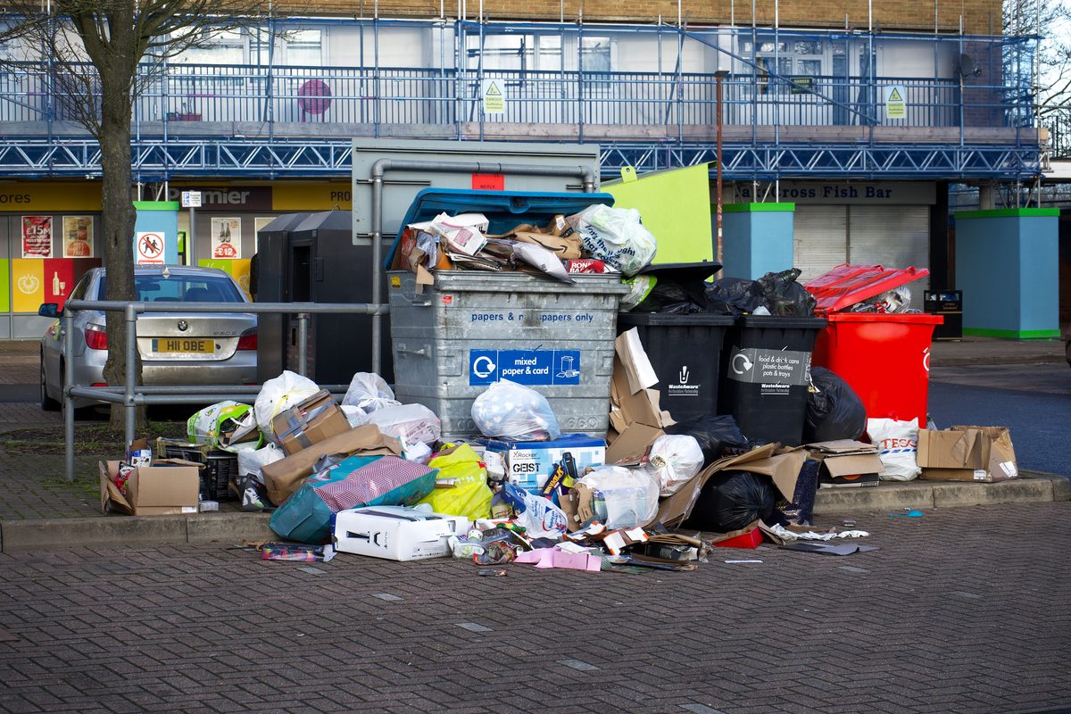 Parking lot with trash and debris before cleanup